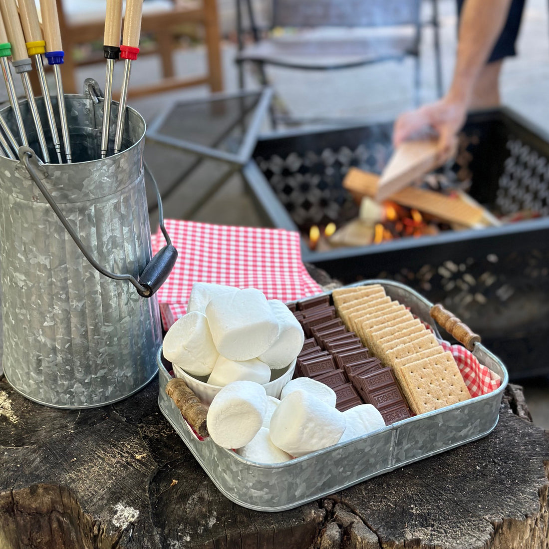 Galvanized tray with marshmallows, chocolate and graham crackers for blog post on how to create a s'mores spread