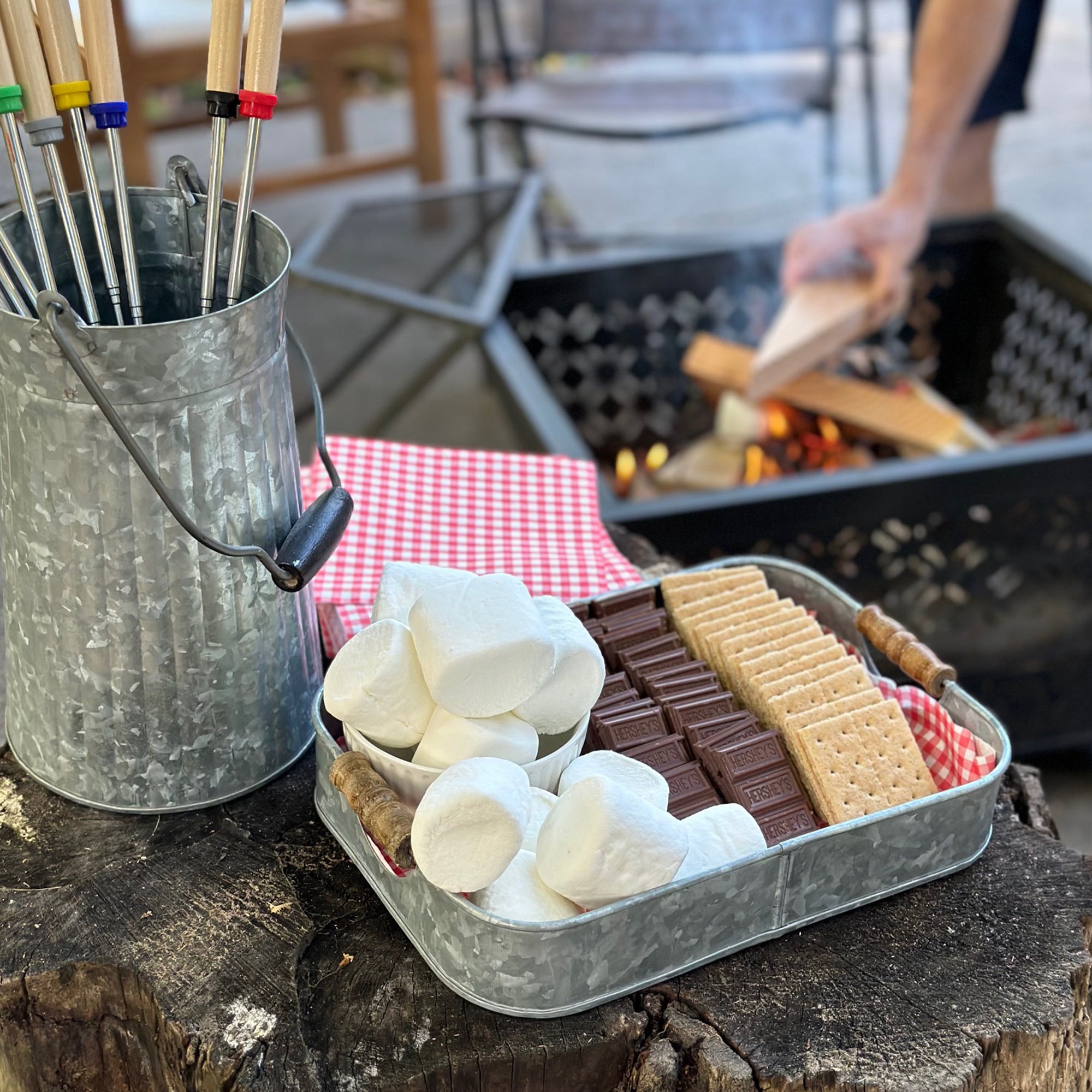 Galvanized tray with marshmallows, chocolate and graham crackers for blog post on how to create a s'mores spread