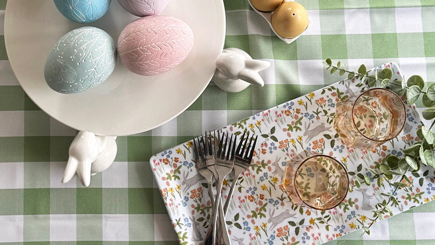 Easter table with rabbit bunny platter easter eggs floral napkin egg shaped salt and pepper shakers