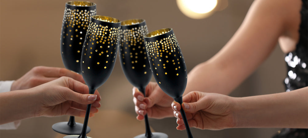 New Year champagne toast 4 black glasses